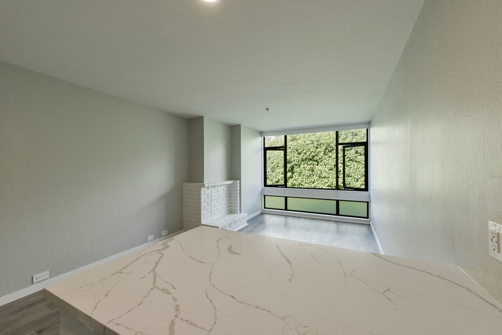 a living room with a marble counter top and a window