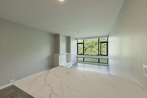 a living room with a marble counter top and a window