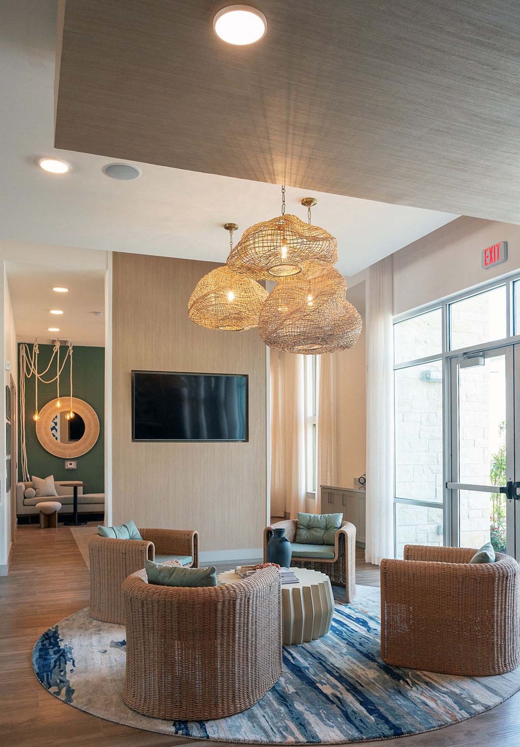 the lobby of a hotel with chairs and a tv