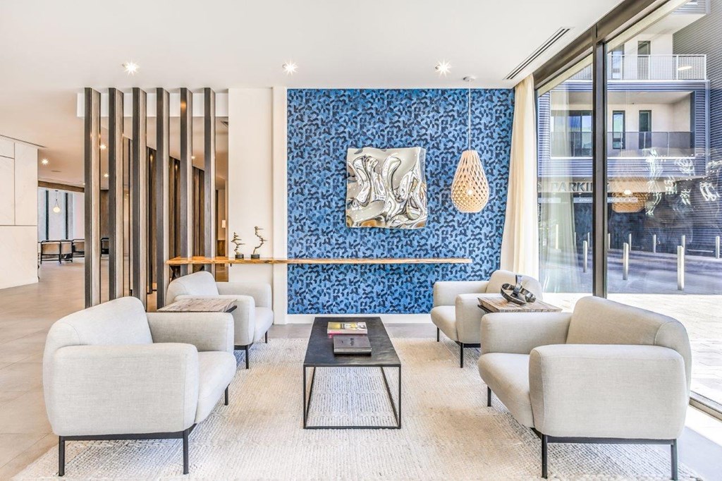 leasing office with white furniture and a blue accent wall