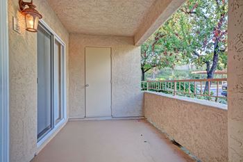 A balcony with a door and a window.
