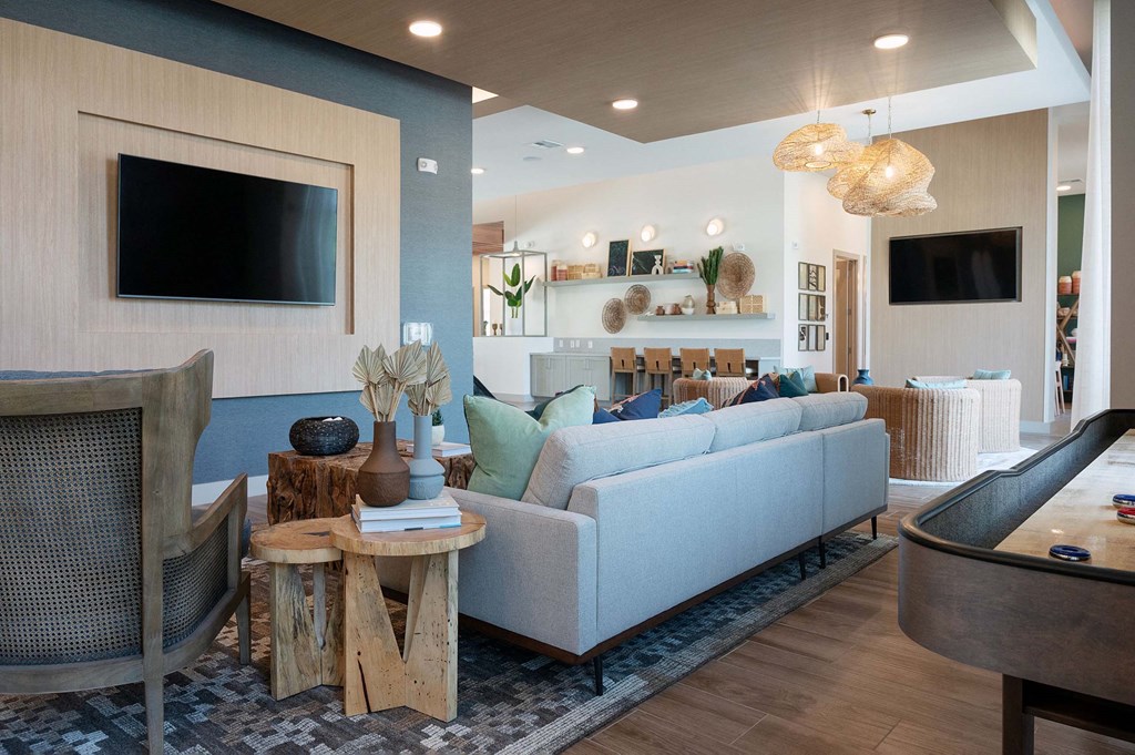 a living room with a blue couch and a television