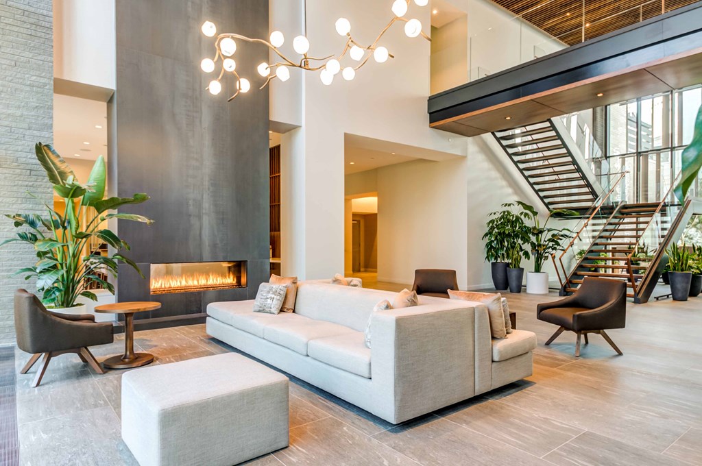 a living room with couches and chairs and a fireplace