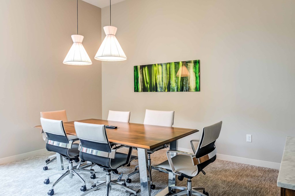 a conference room with a wooden table and chairs