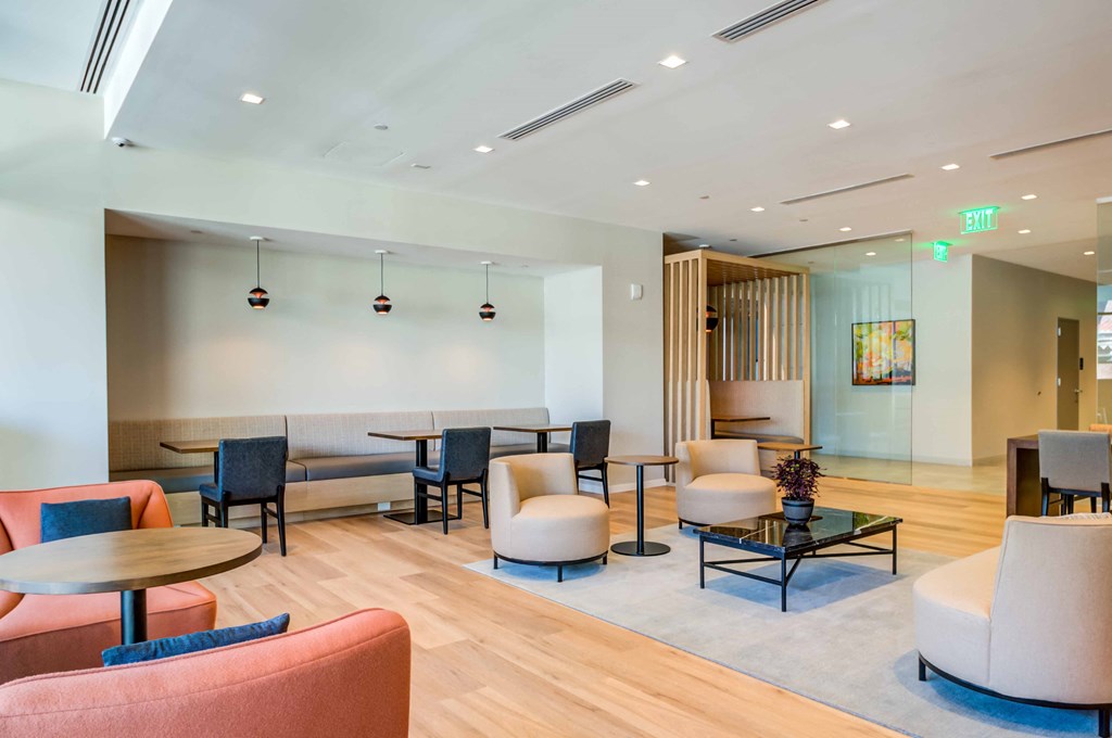 a lobby with couches and chairs and tables