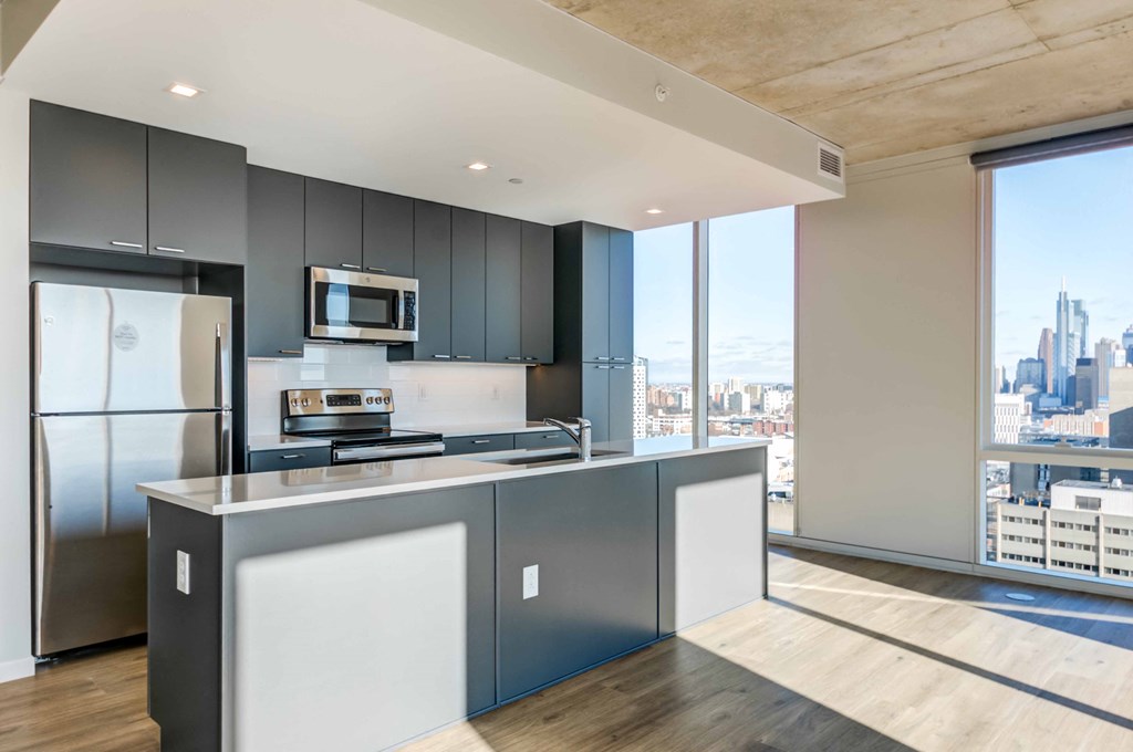 a large kitchen with a large window and a city view