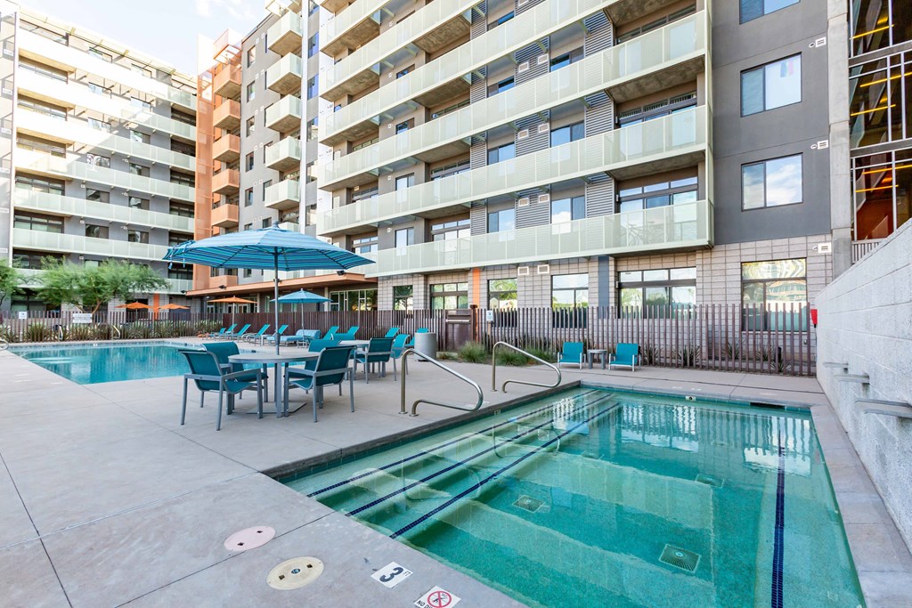 a swimming pool in front of an apartment building