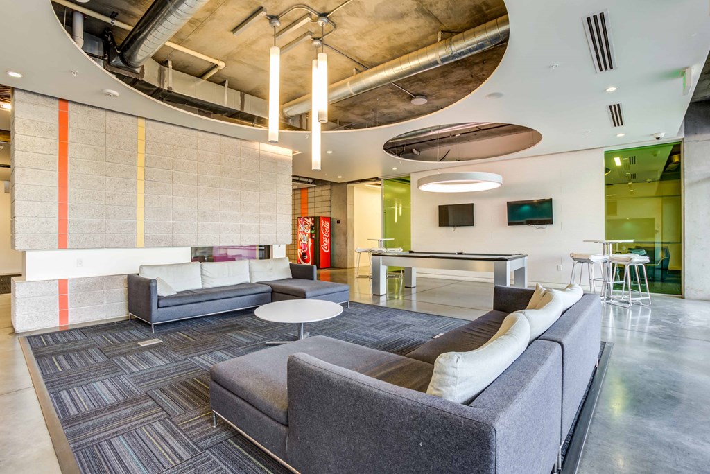 a lobby with couches and chairs and a table