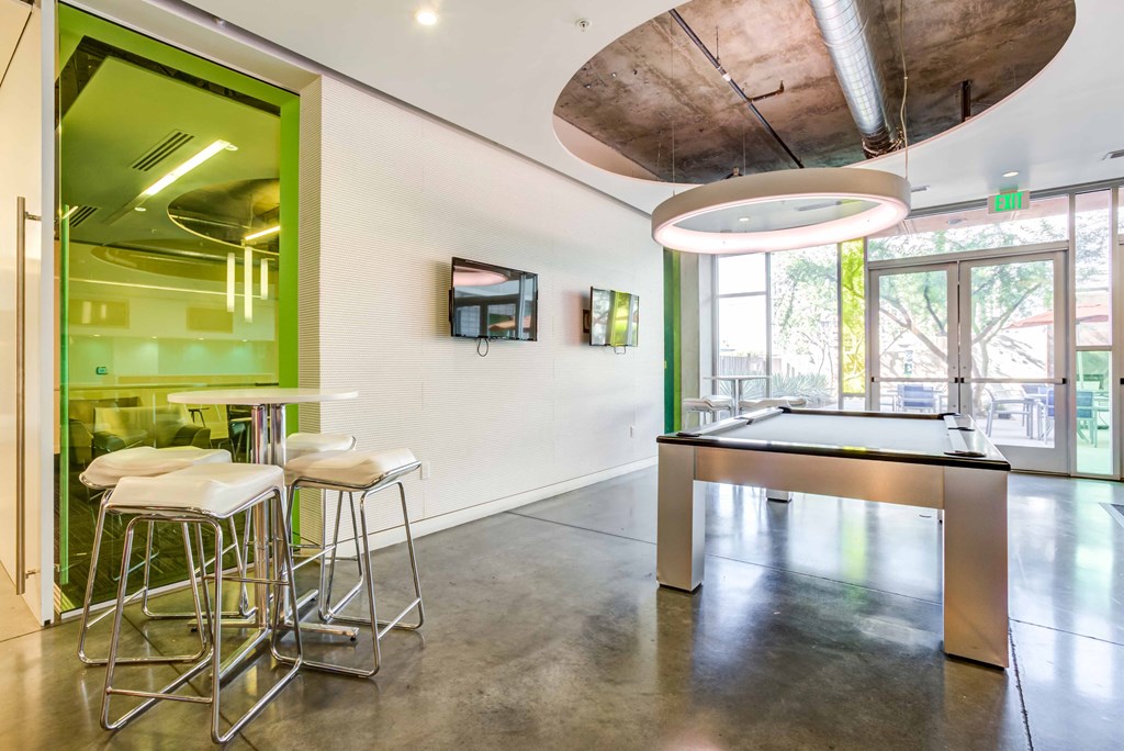 a game room with a bar and a ping pong table