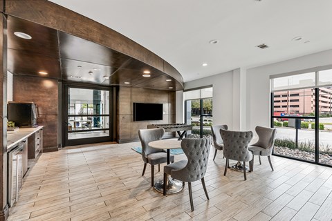 A modern kitchen with a dining table and chairs.
