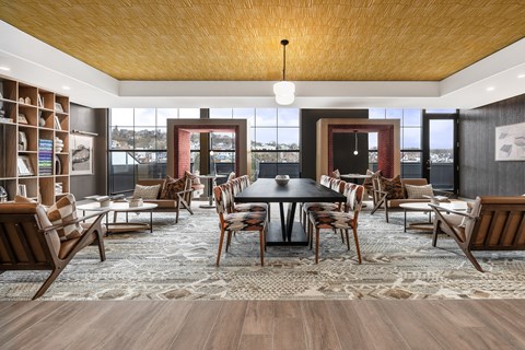 A modern dining room with a large table and chairs.