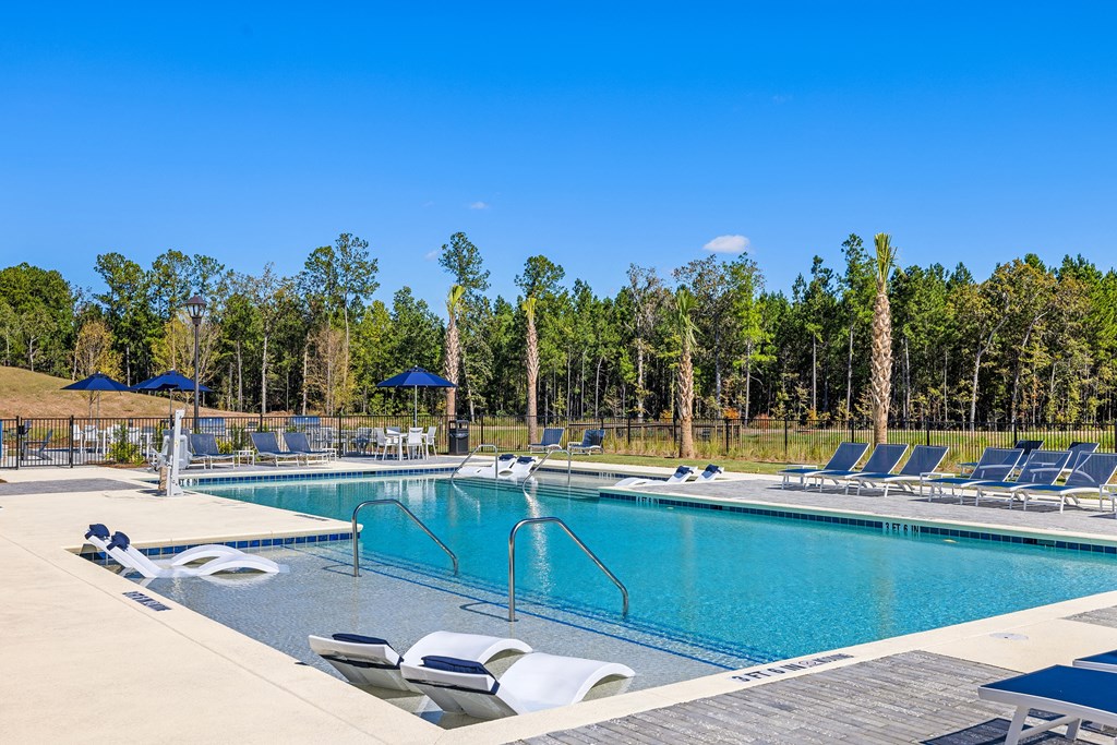 swimming pool with lounge chairs on aqua sundeck