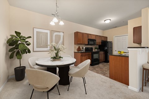 A modern kitchen with a dining table and chairs.