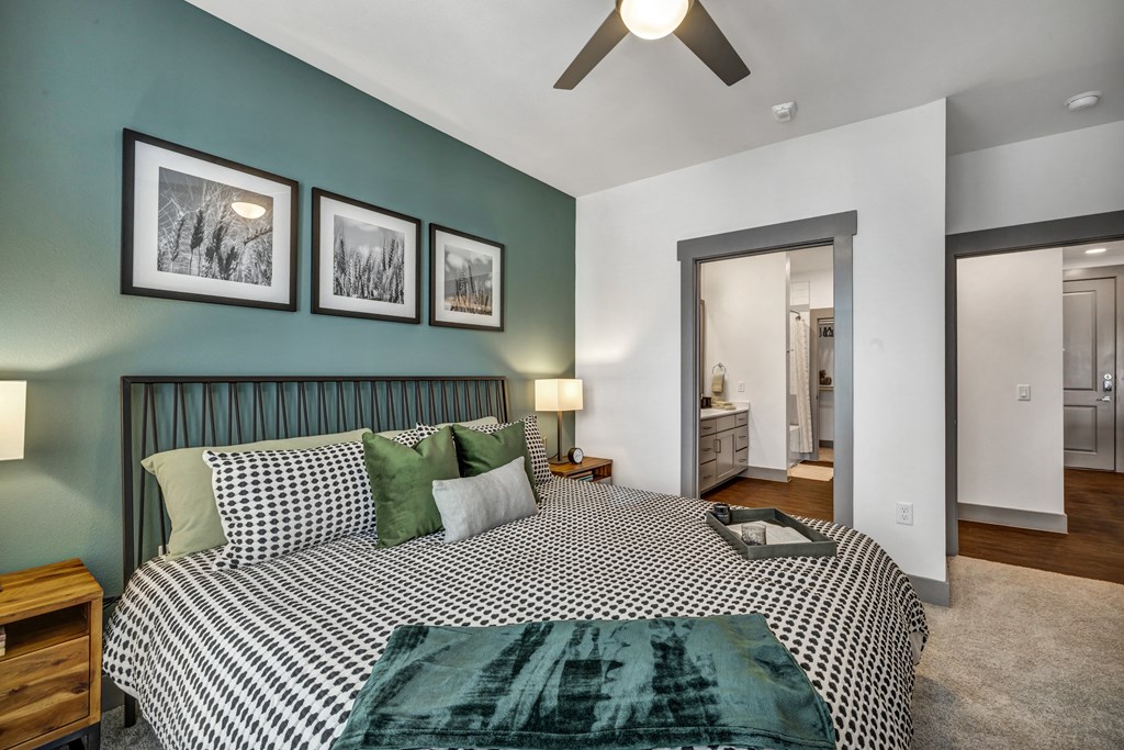 a bedroom with a bed and a ceiling fan