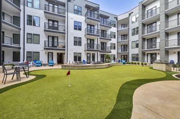 a putting green in the middle of an apartment building