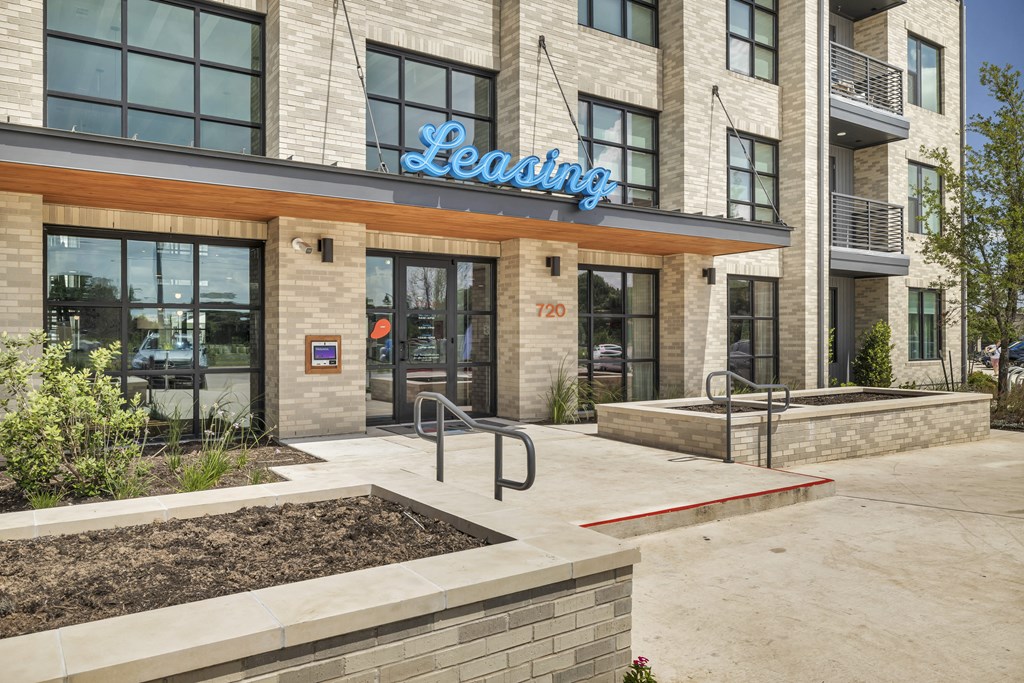 a building with a leasing sign on the front of it