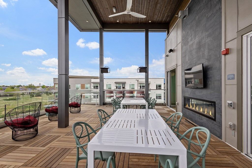 Rooftop patio with table and fireplace