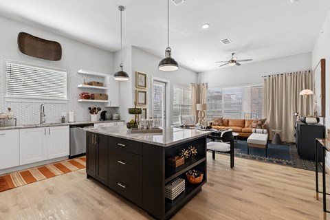 A modern kitchen with an island and a dining area.