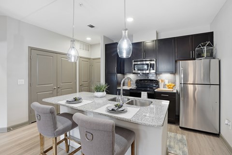 A modern kitchen with a dining table and chairs.