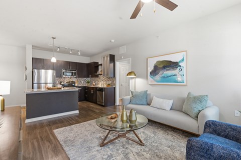 A modern living room with a grey sofa and a coffee table.