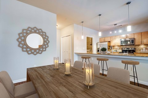 A dining room with a wooden table and chairs.