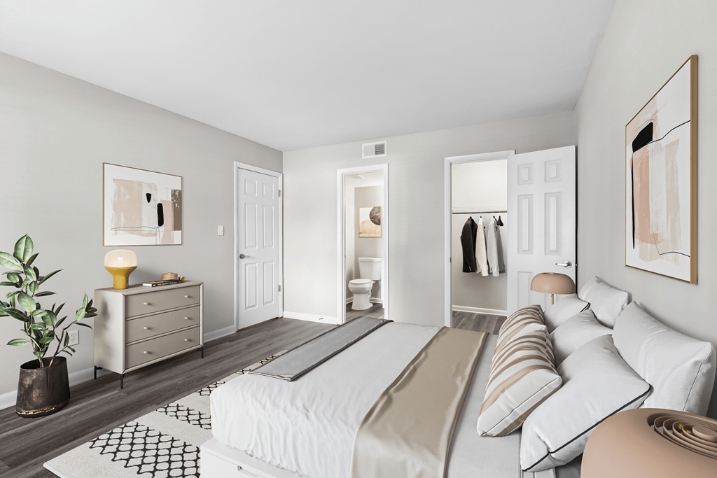 a bedroom with a large bed and a bathroom