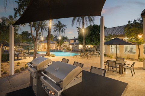 a backyard with a grill and a swimming pool