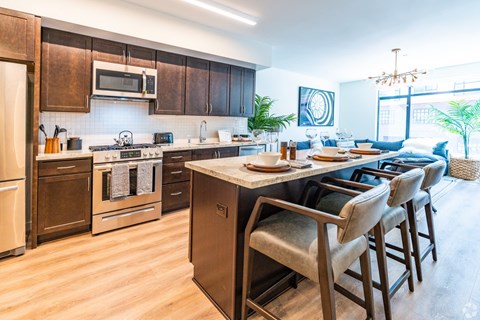 A kitchen with brown cabinets and a white countertop.