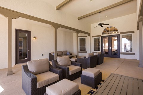 a living room with couches and chairs and a wooden deck