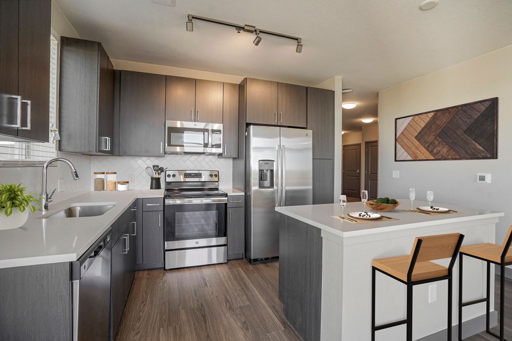 Kitchen with dark wood cabinets and kitchen island  at Novus, Colorado