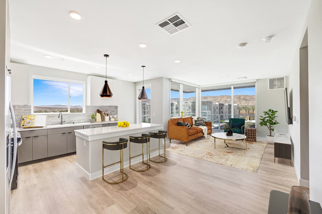 a kitchen and living room with a large window and a view of the city