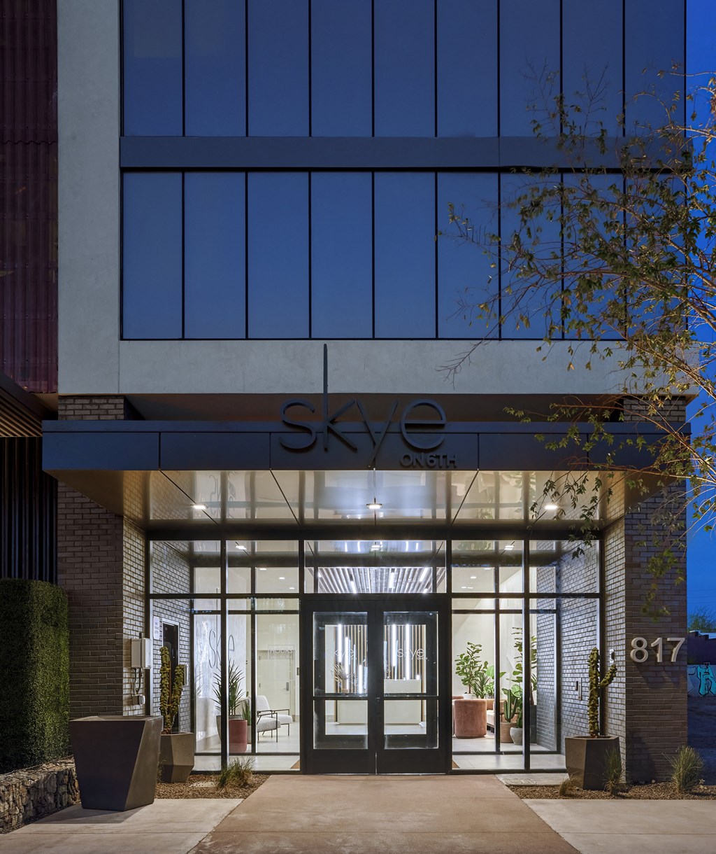 the entrance to the sky office building at night