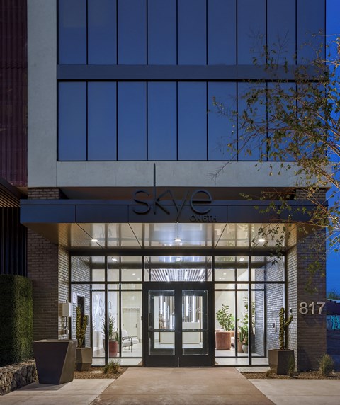 the entrance to the sky office building at night
