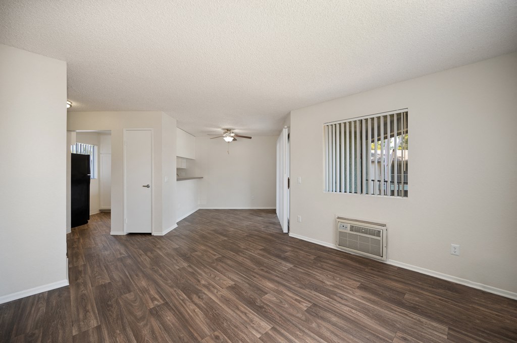 a 1-bedroom apartment living room and dining room with wood flooring