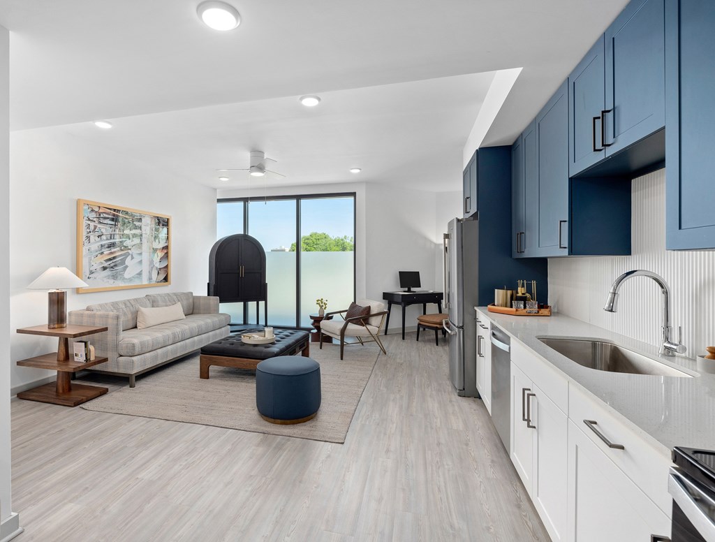 A modern kitchen with a dining area and a living room.