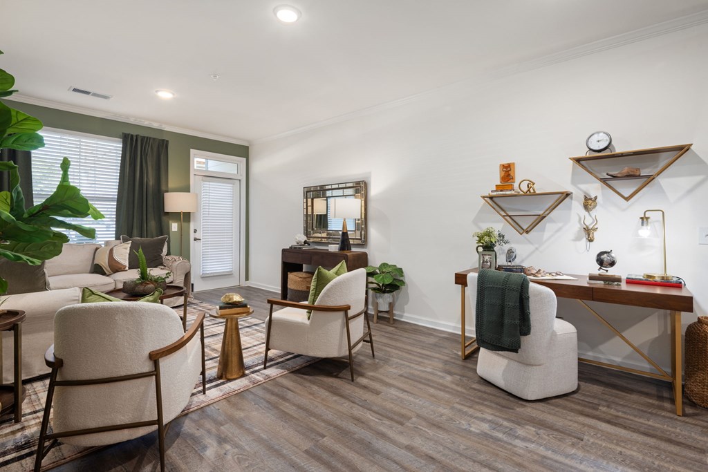 A living room with a white chair and a white sofa.