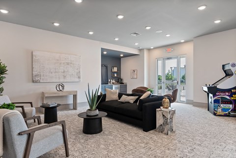 a living room with a couch and chairs and a piano