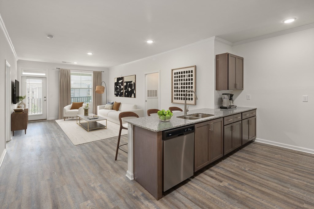 A modern kitchen with a wooden floor and a large island.