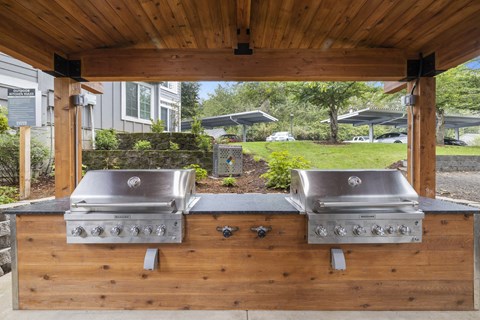 Covered outdoor grill area with two stainless steel appliances at Canyon Creek, Wilsonville, OR, 97070