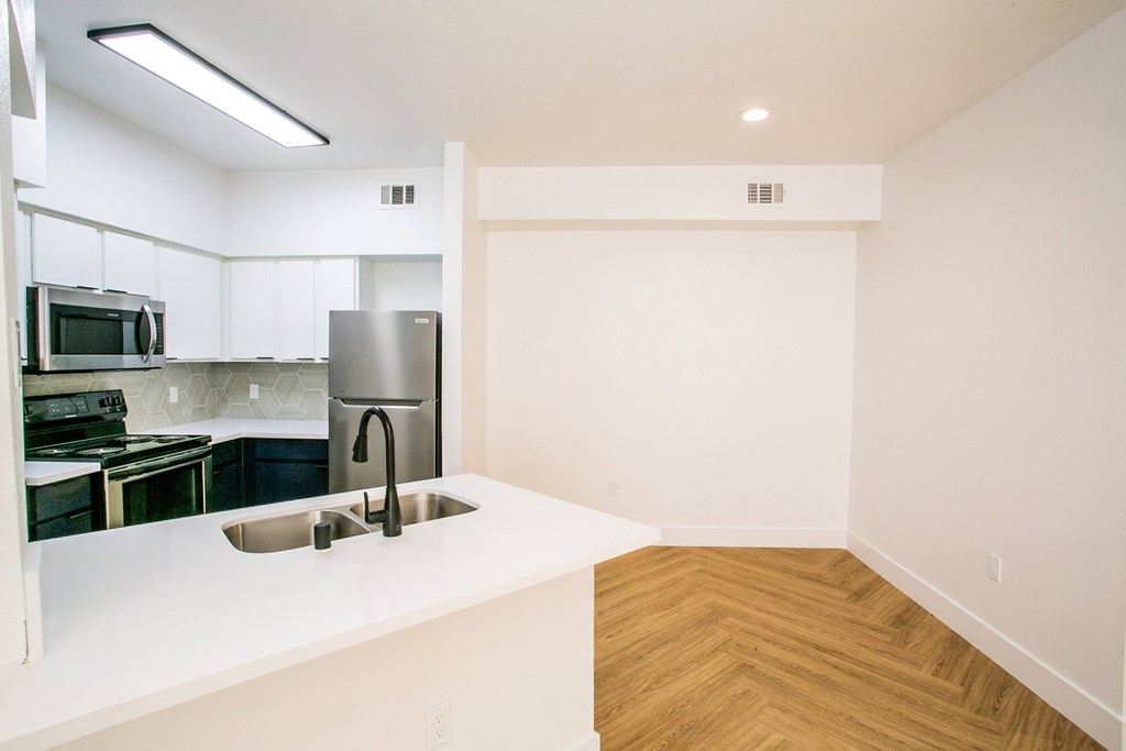 Kitchen with white counter and stainless steel appliances