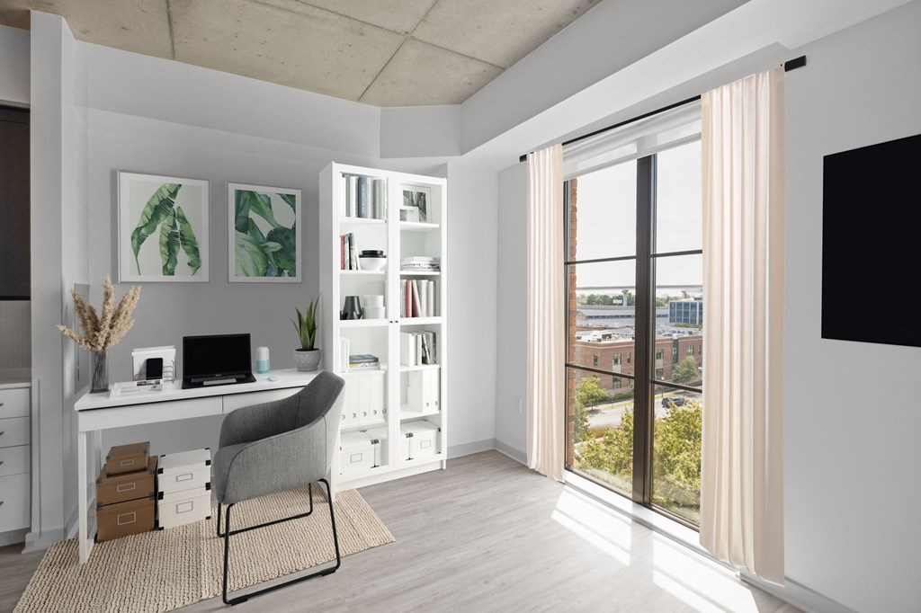 a home office with a white desk and chair and a large window with a view of the