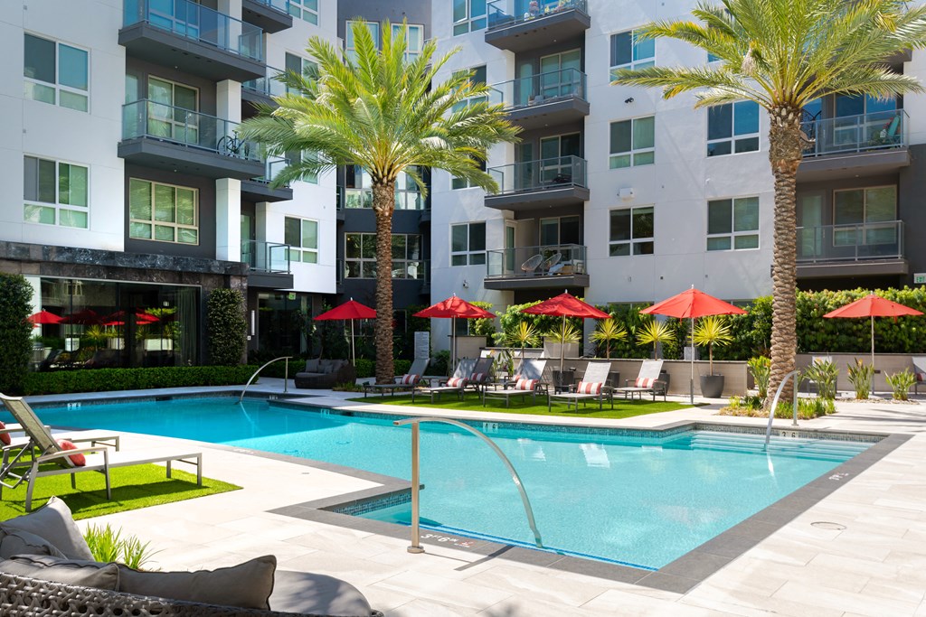 a swimming pool in front of an apartment building at VORA LUX, San Diego California