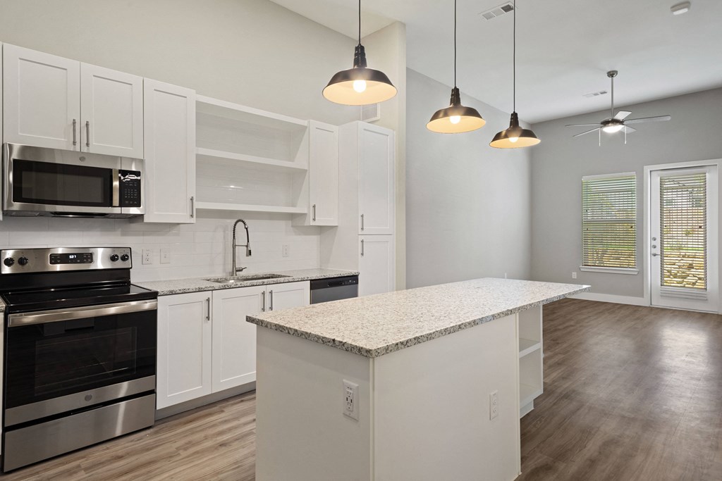 a kitchen with white cabinetry and an island