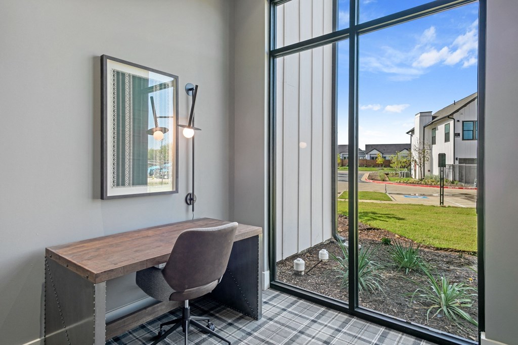 an office with a large window and a desk with a chair