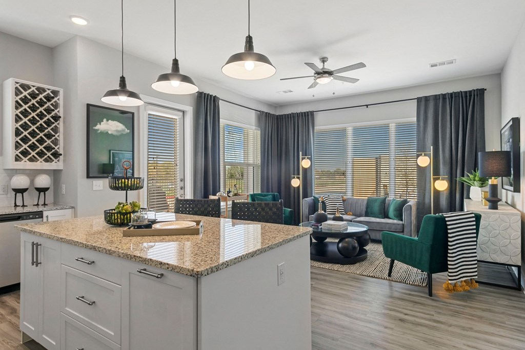 a kitchen island in a living room with a couch and