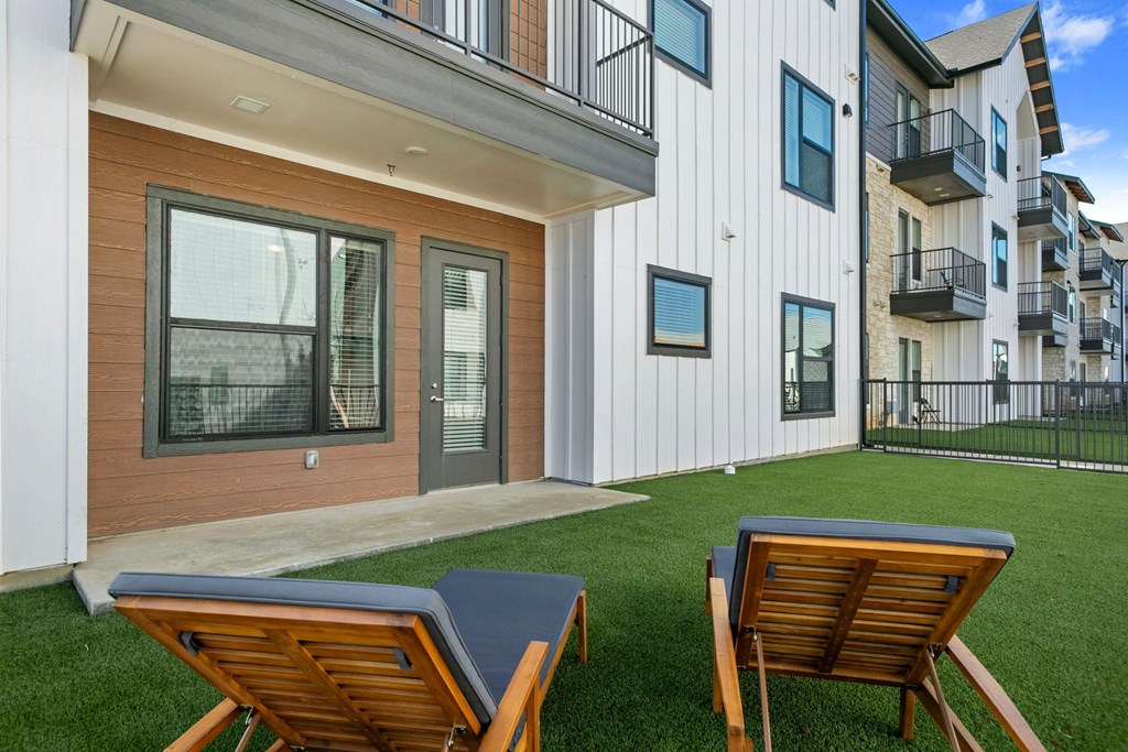 our apartments offer a private backyard with lounge chairs