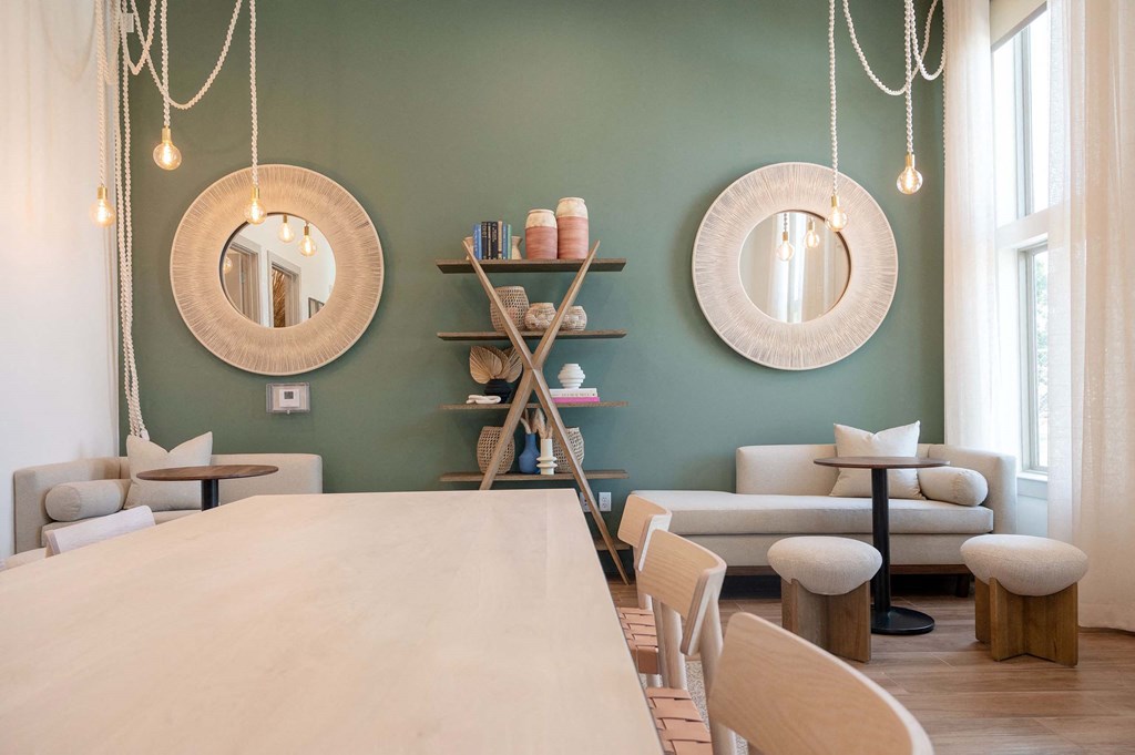 a communal table and chairs in a room with mirrors on the wall