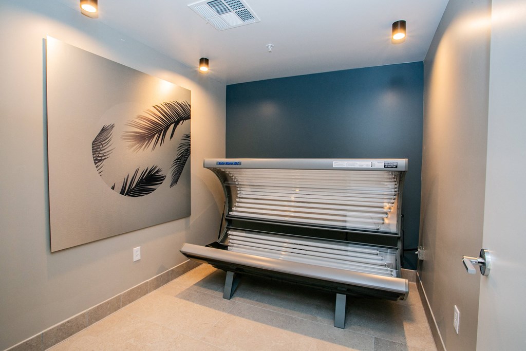 Tanning bed against the wall with wall decor.