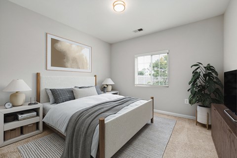 A bedroom with a large bed and a painting on the wall.