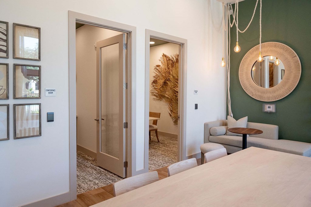 a dining room and living room with a table and two doors